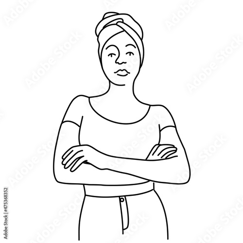 Young African woman stands with crossed arms.