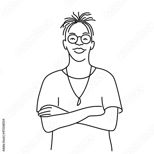Stylish guy with glasses stands with crossed arms.