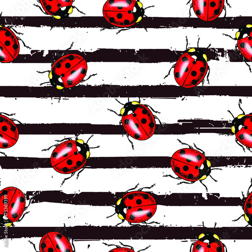 Vector seamless pattern of randomly scattered red ladybugs on black and white striped background.