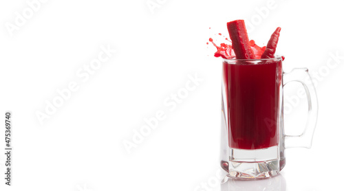 Glass of turnip juice with carrot on white background