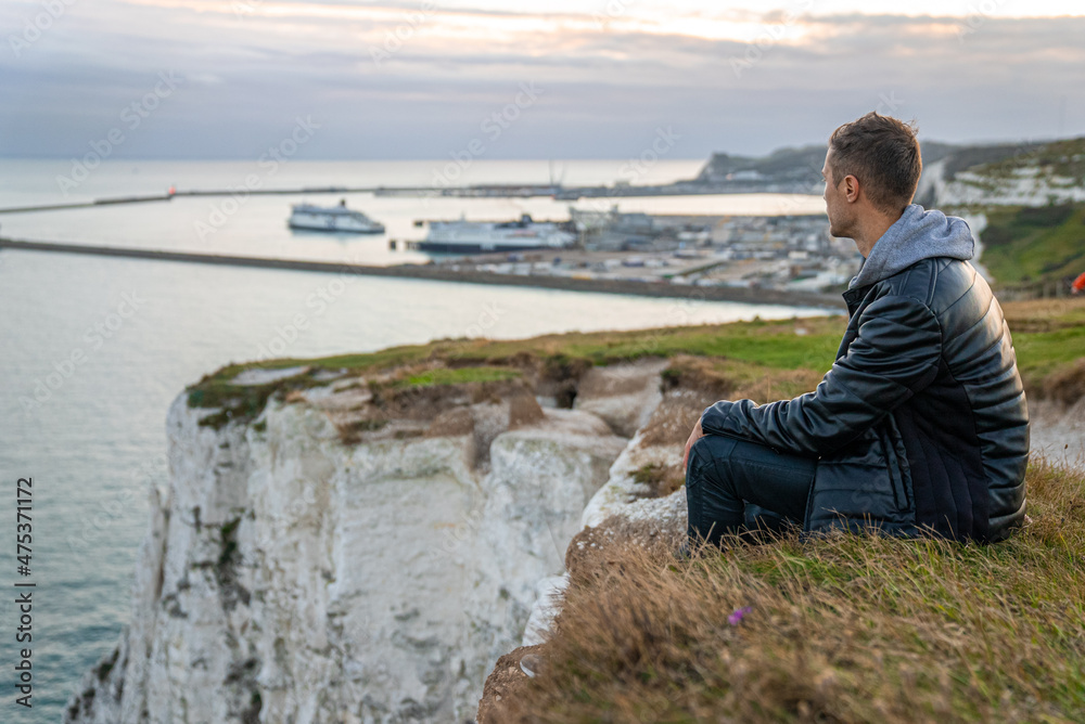 Young man exploring the White Cliffs of Dover in UK. Young man exploring the White Cliffs of Dover in UK.