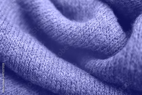 Close up of purple knitted textured background. Trendy color. Color 2022. Color of the year Very Peri.