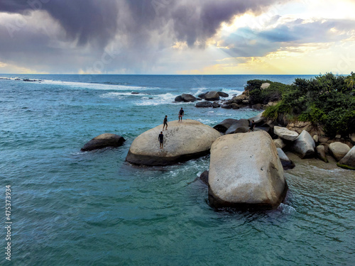 Sand beach among rocks on evening sunset. La piscina beach in National park Tayrona, Colombia