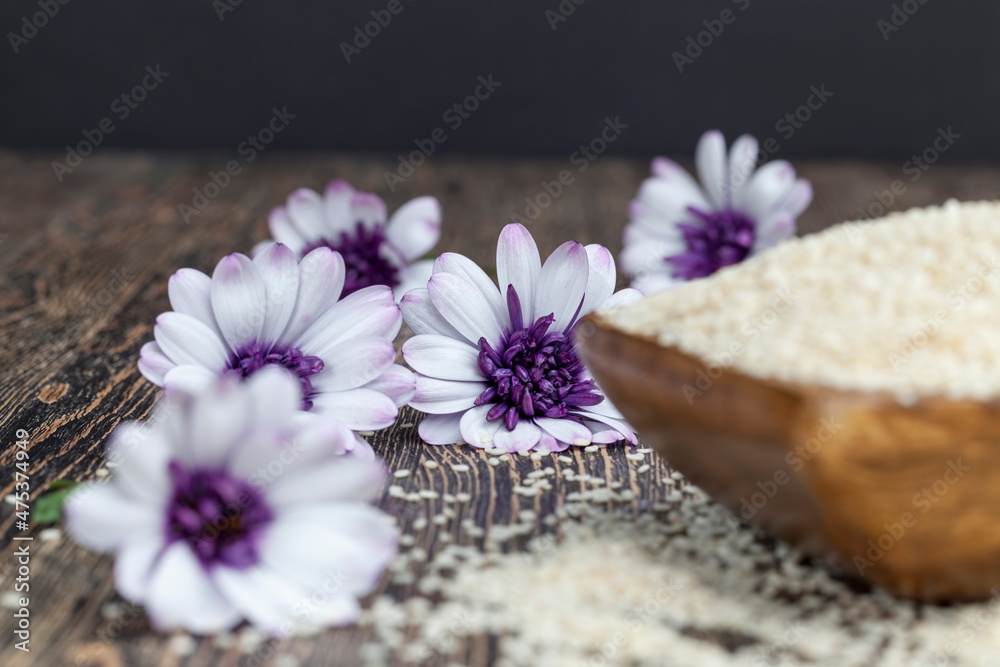 white sesame seeds on a wooden table white sesame seeds on a wooden table