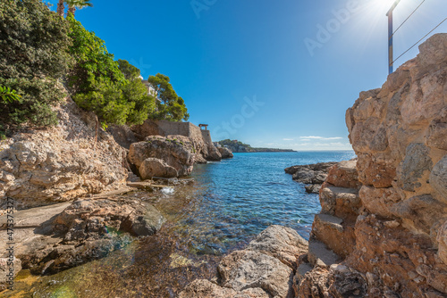 Majorcan coastal area of rocks with calm sea and blue sky