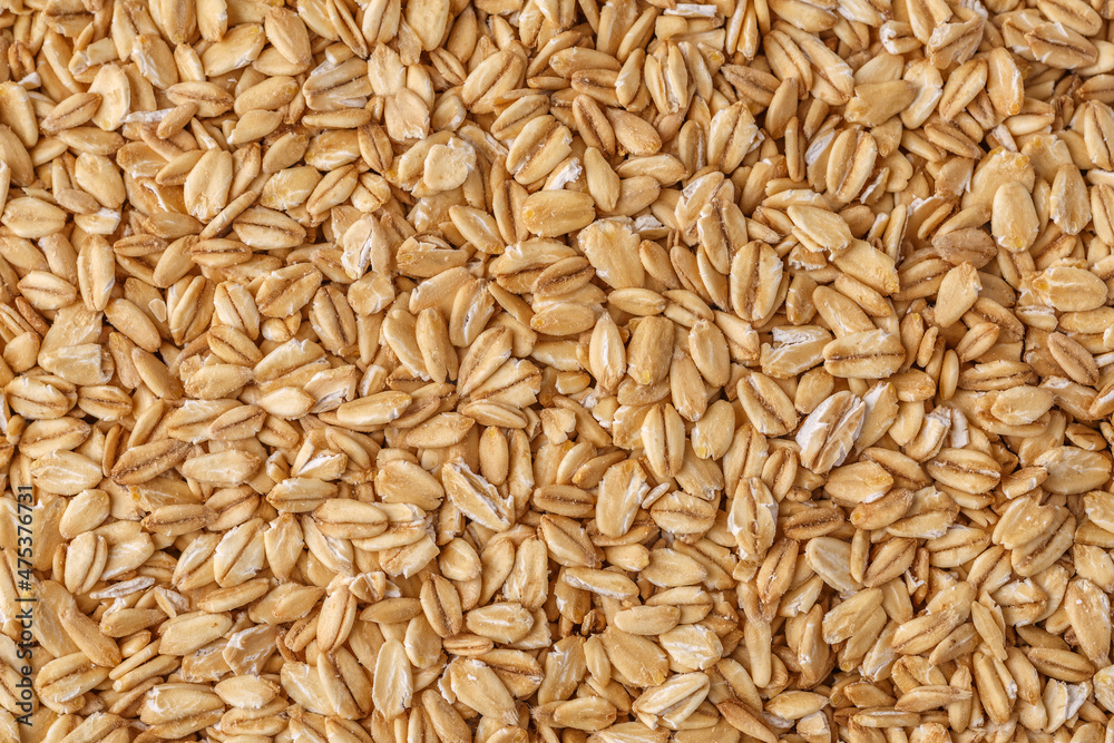 Rolled oat, oat flakes background or texture. Close up, directly above.Heap of dry rolled oats isolated. Rolled oat, oat flakes background or texture. Close up, directly above.Heap of dry rolled oats isolated.