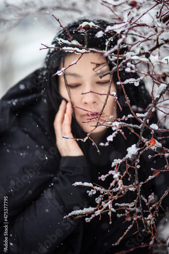 Portrait of a woman near a branch. Winter photo session