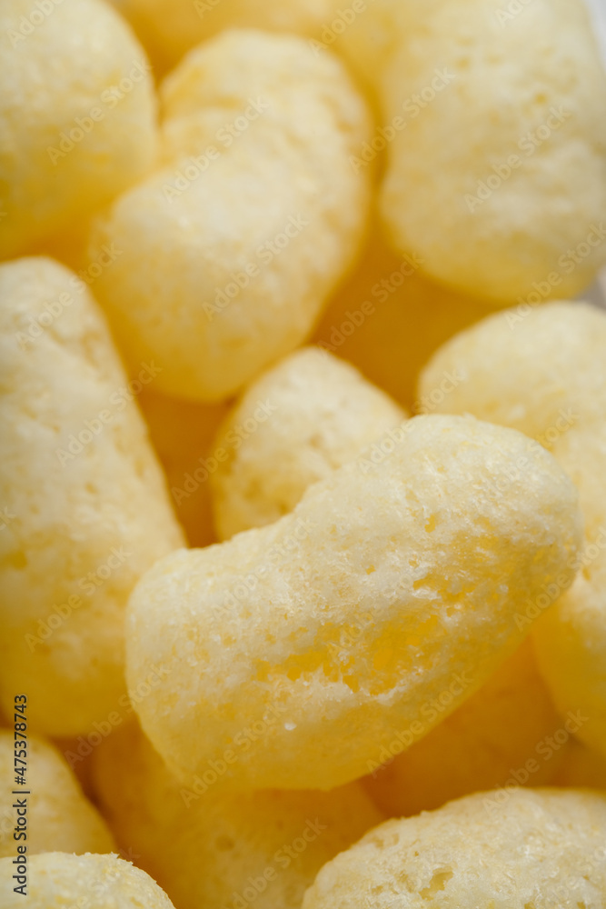Corn sticks in powdered sugar as a texture, crispy sweets Corn sticks in powdered sugar as a texture, crispy sweets