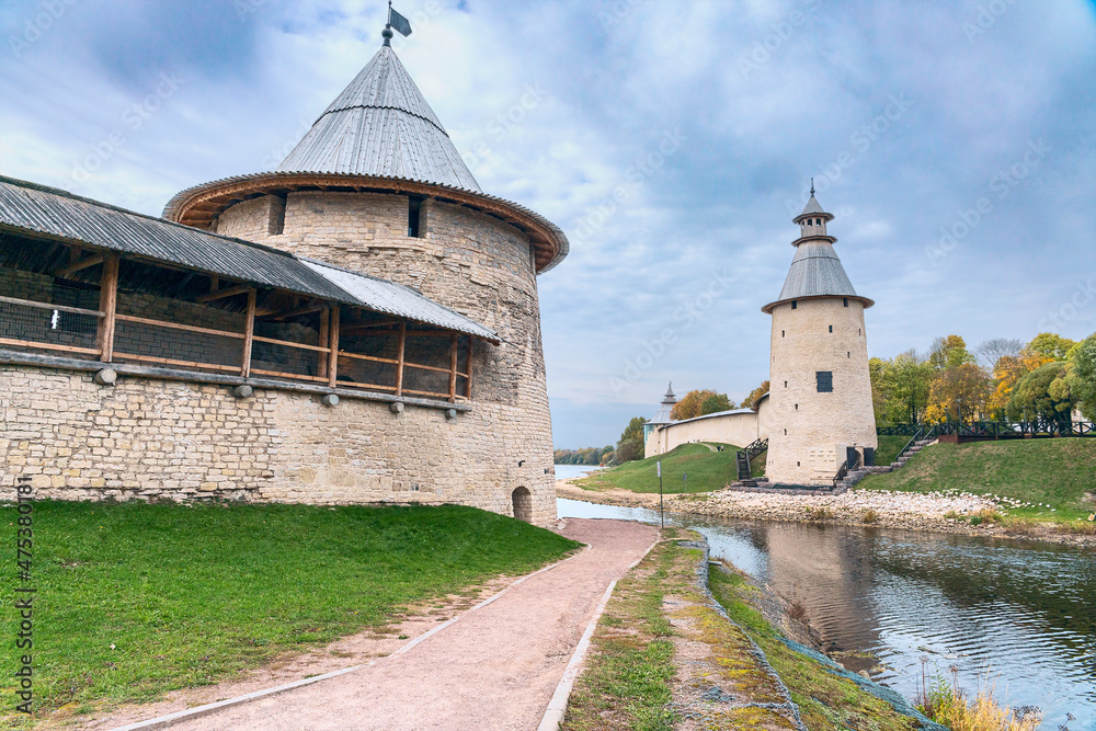 powerful watchtowers along the old fortress wall on the river bank in the ancient Russian city of Pskov