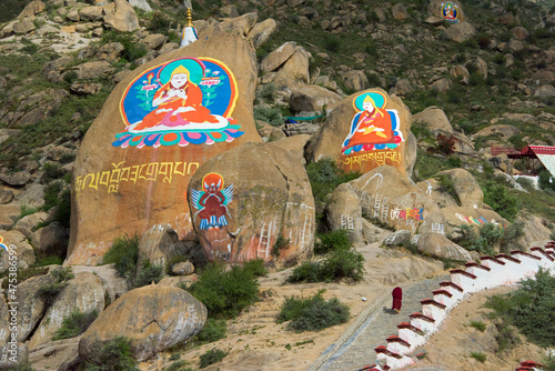 Foto Image of Buddha painted on rock, Drepung Monastery, one of the great three Gelug