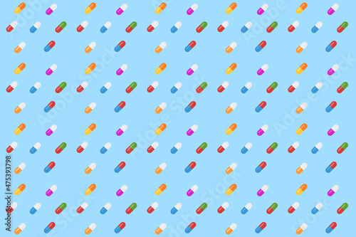 Colorful pattern of pills and capsules on a blue. Seamless pattern