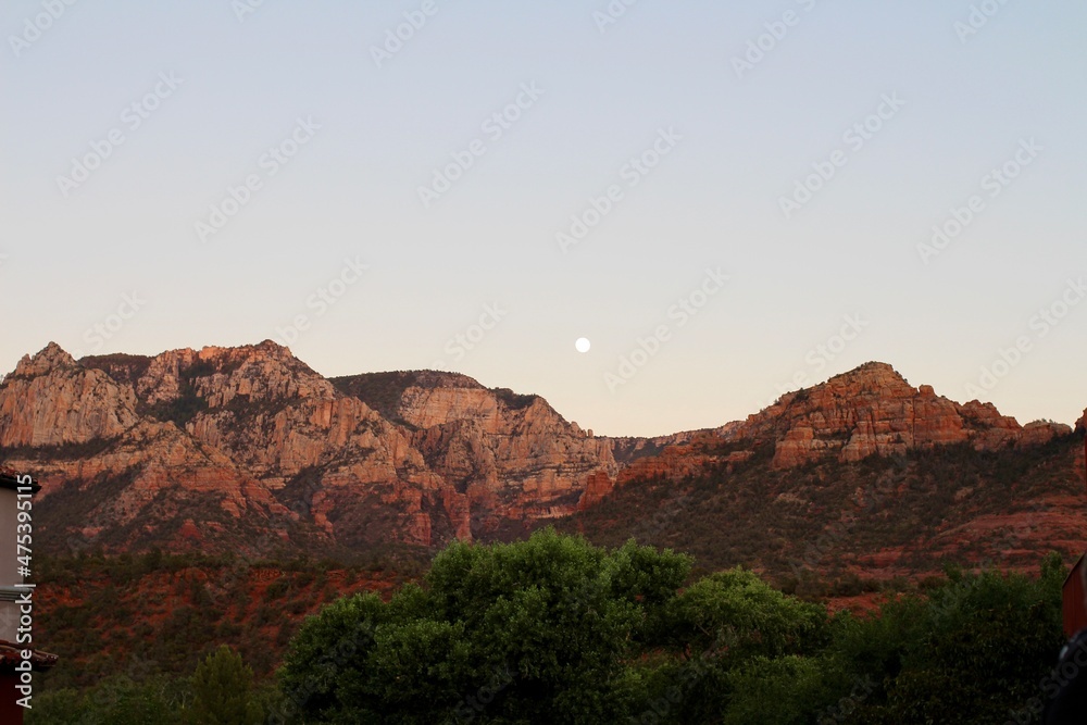 valley at sunset with moon
