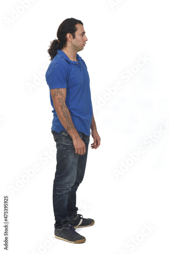 side view of a man with ponytail and tattoo on white background