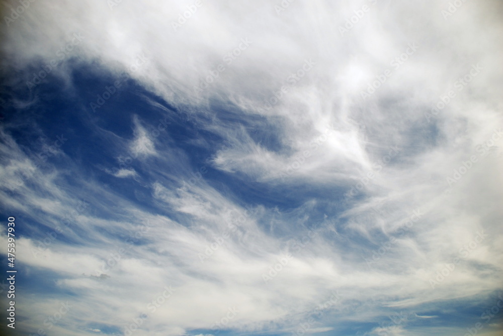 White cirrus clouds over the sky. The light blue sky is flooded with the sun, high white cirrus clouds float across the sky. They stretched out over great distances. White cirrus clouds over the sky. The light blue sky is flooded with the sun, high white cirrus clouds float across the sky. They stretched out over great distances.