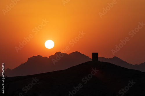 Middle East, Arabian Peninsula, Oman, Ad Dakhiliyah, Nizwa. Sunset over the mountains in Nizwa, Oman.