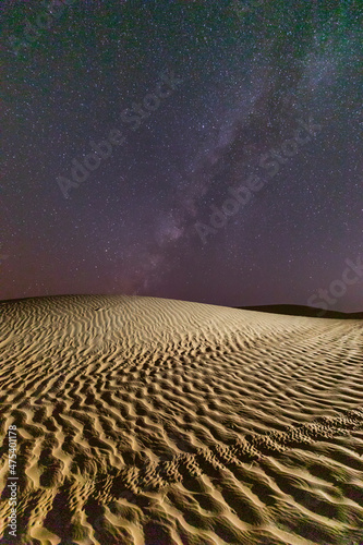 Middle East, Arabian Peninsula, Ash Sharqiyah North, Bidiyah. Stars over a sand dune in the desert of Oman. photo