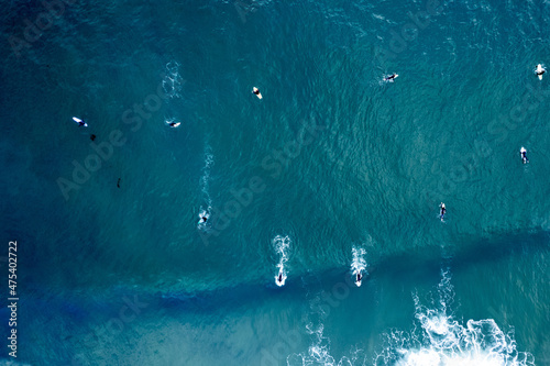 Aerial view of surfers riding the waves in Newport Beach, California