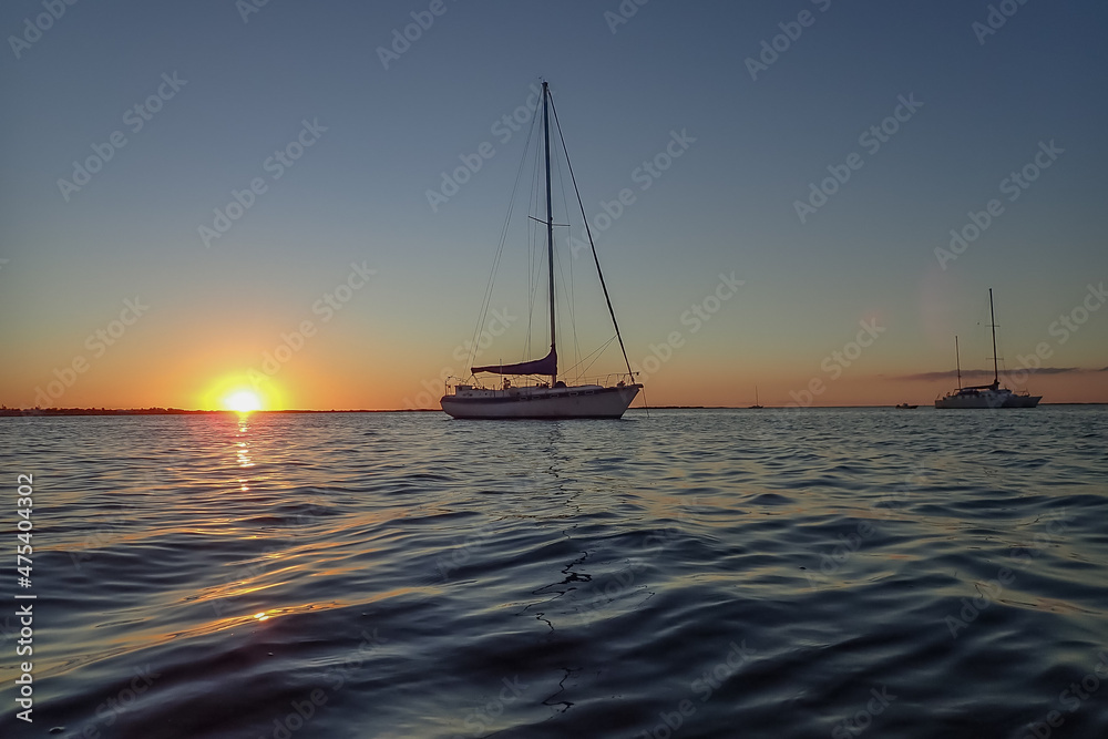 Sailboat silhouettes in the ocean at sunset
Sailboat silhouettes in the ocean at sunset