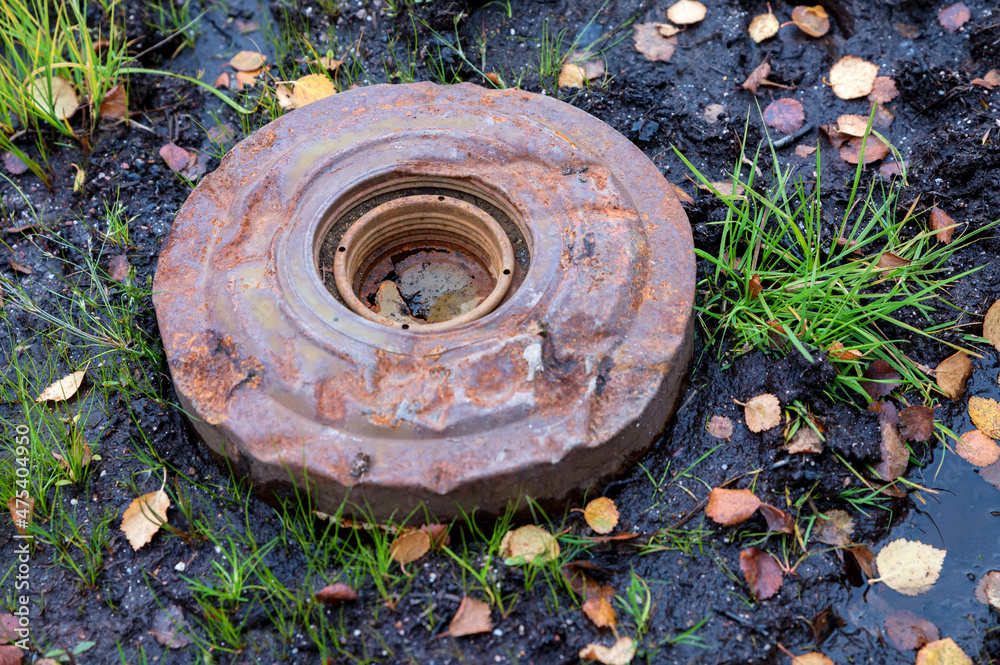 An old anti-personnel mine on the ground An old anti-personnel mine on the ground