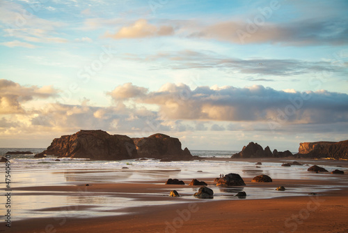 Bandon Beach Oregon sea stacks with colorful sunset sky and clouds. photo