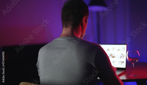 Man secretly watching porn sites at night.