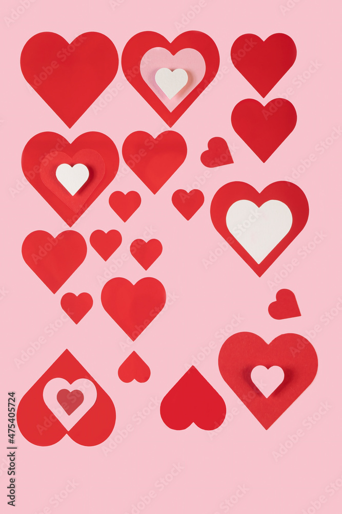 Multiple sizes and colors of hearts cut out of paper
