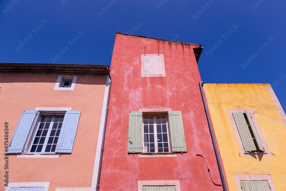 Europe, France, Roussillon. Exterior of painted houses.