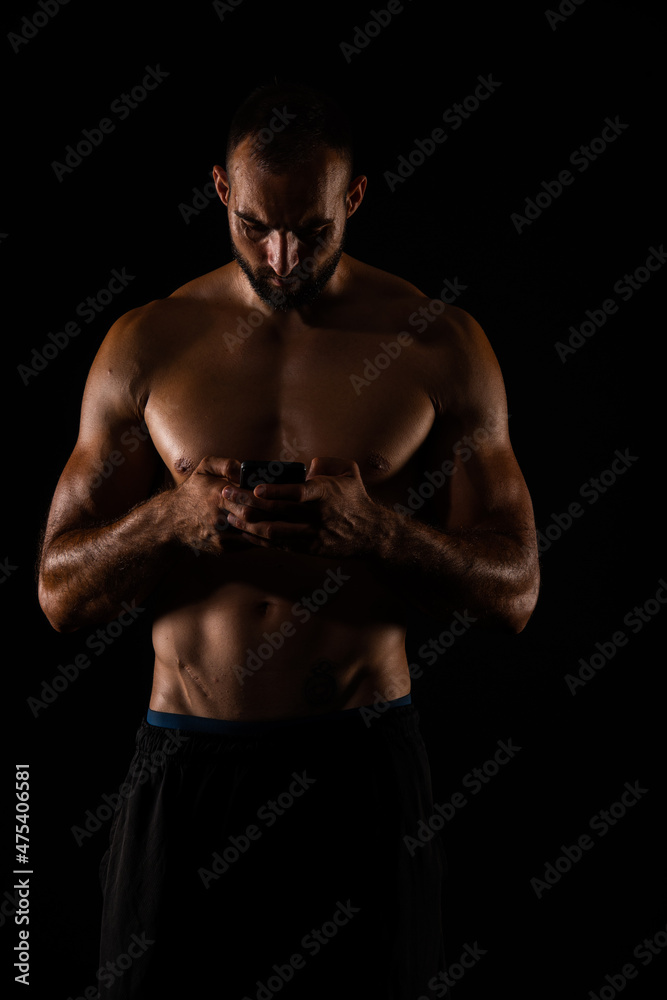 Fototapeta premium Checking his phone while taking a break