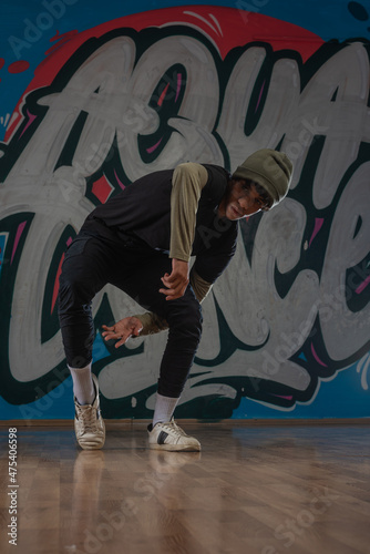 Modern rapper dancing in garage. Urban lifestyle, hip hop.