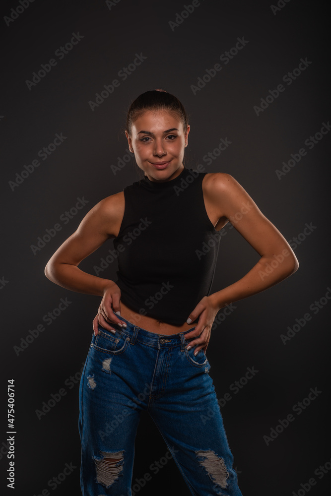 Smiling and posing with her hands on her hips Smiling and posing with her hands on her hips