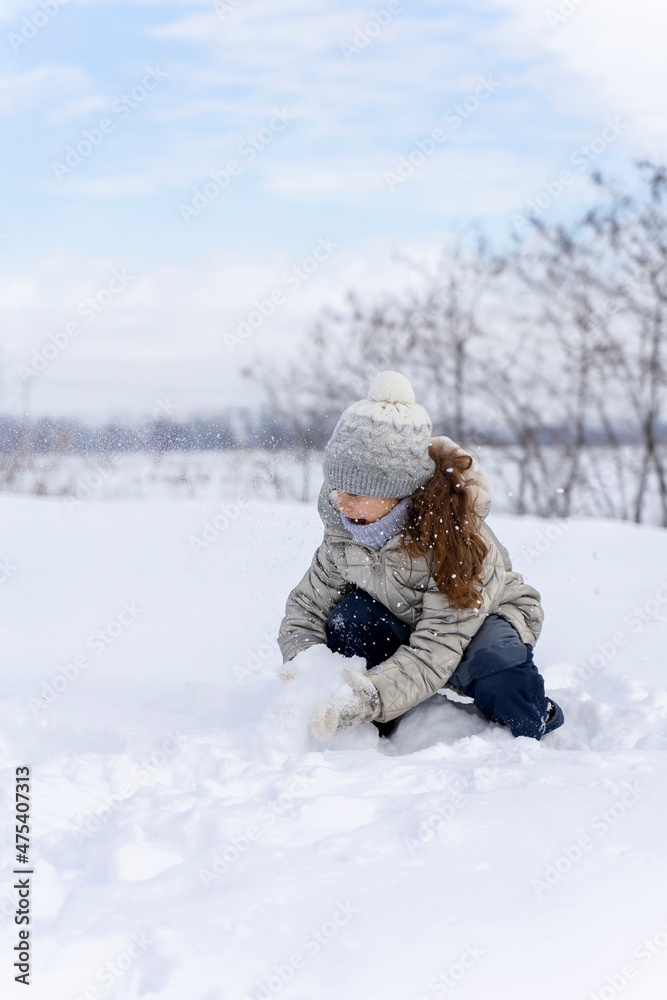 Happy children play snowballs, run, throw snow. Funny kids play games indoors in the winter with snow