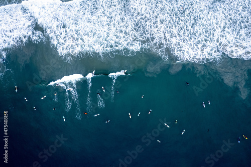 Aerial view of surfers riding the waves in Newport Beach, California photo