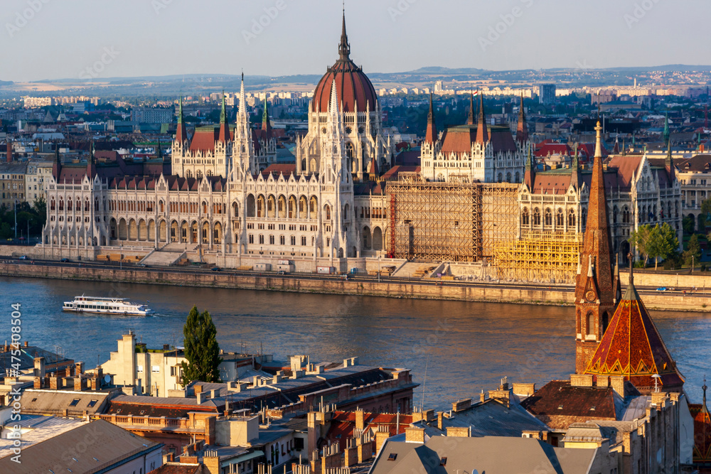 Tour boat passes Hungary's Parliament, built between 1884-1902 is the country's largest building. It has 691 rooms and sits next to the Danube River, Budapest, Hungary.