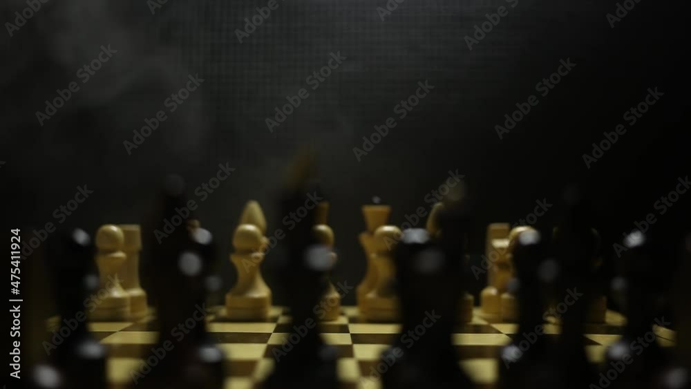 A chess game in sullen shadow with black and white game pieces in smoke, ready to play.
A chess game in sullen shadow with black and white game pieces in smoke, ready to play.