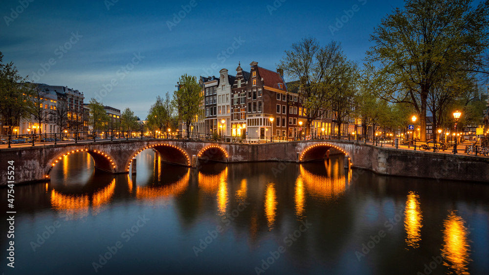Naklejka premium Europe, The Netherlands, Amsterdam. Canal scene at sunset.