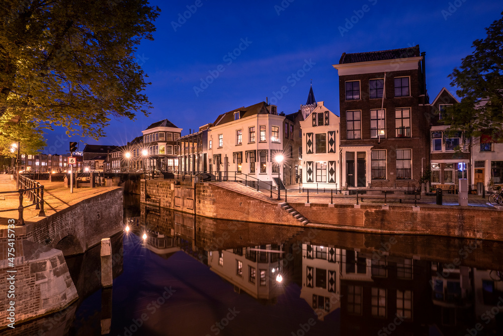 Europe, The Netherlands, Schiedam. Canal and town at night.