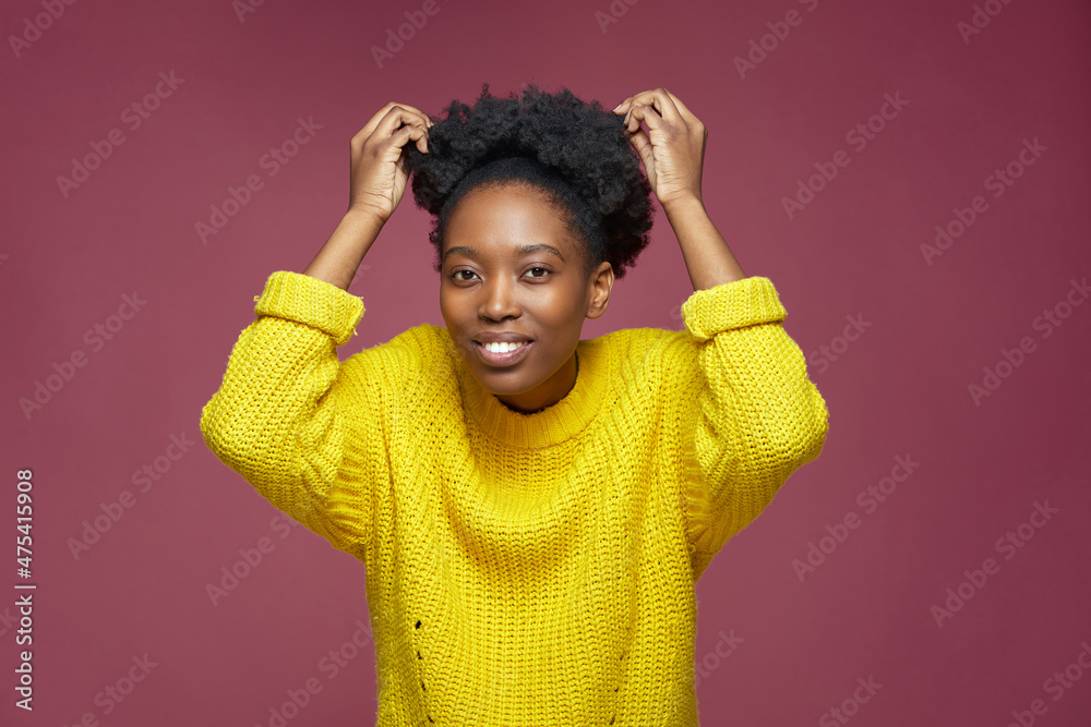 Pretty young african american woman fix short afro hairs, coiffure preening, during beauty routine. Haircare concept