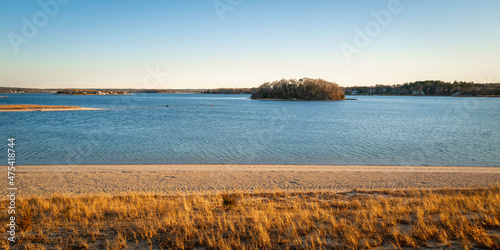Panoramic beach and seawater landscape with the view of the island and blue sky.
