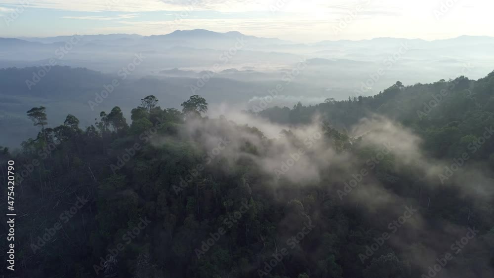 Aerial view Drone flying through the fog above mountain peak Beautiful light sunrise or sunset nature Landscape Amazing video cinematic nature view in Thailand on December 15-2021 Aerial view Drone flying through the fog above mountain peak Beautiful light sunrise or sunset nature Landscape Amazing video cinematic nature view in Thailand on December 15-2021
