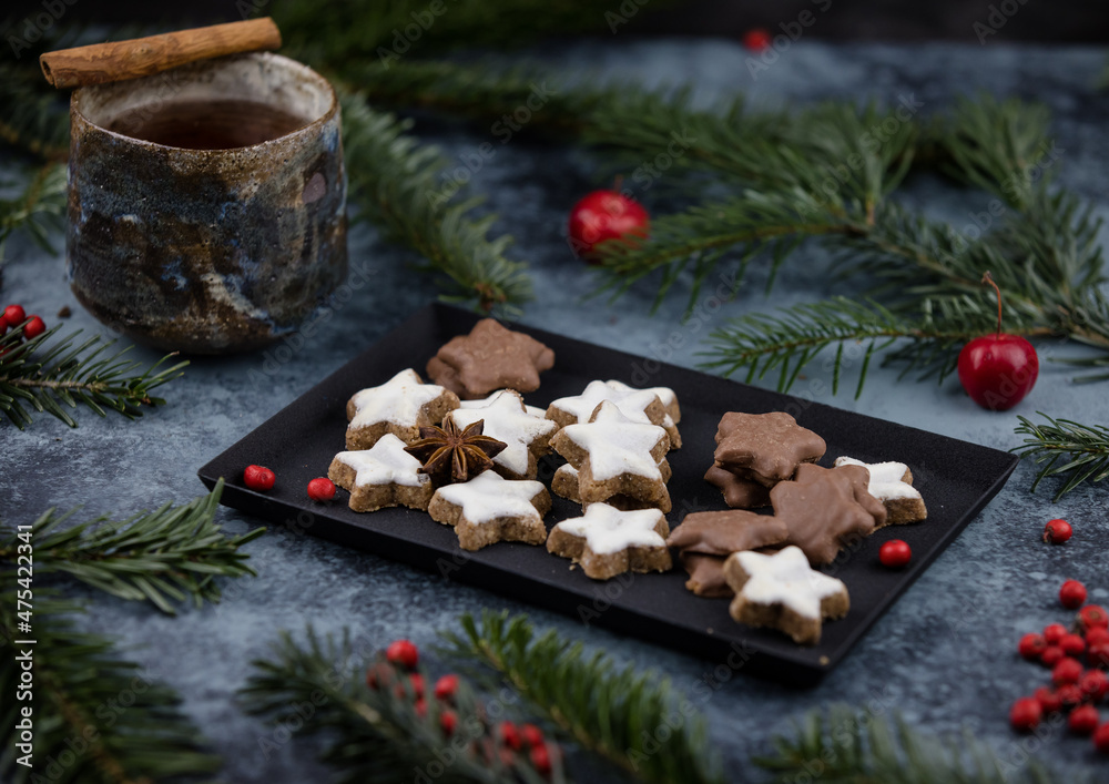 Christmas cookies on a decorated table with tea 