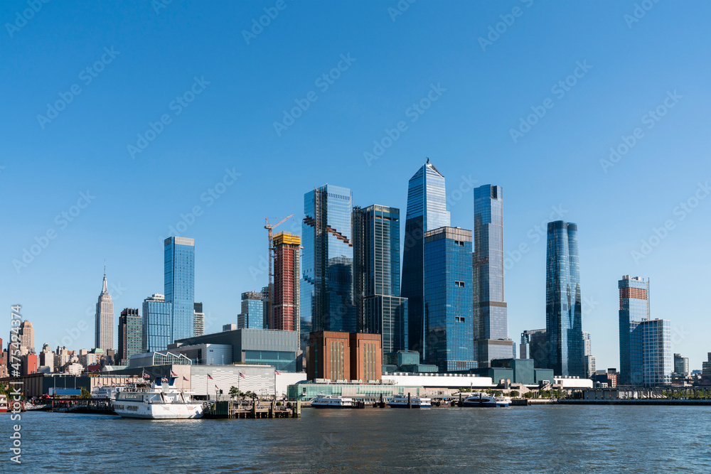 New York City skyline from New Jersey over the Hudson River with the skyscrapers of the Hudson Yards district at day time. Manhattan, Midtown, NYC, USA. A vibrant business neighborhood New York City skyline from New Jersey over the Hudson River with the skyscrapers of the Hudson Yards district at day time. Manhattan, Midtown, NYC, USA. A vibrant business neighborhood