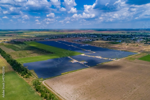 Wallpaper Mural Solar power plant, solar panels shot from a drone, blue sky and clouds Torontodigital.ca