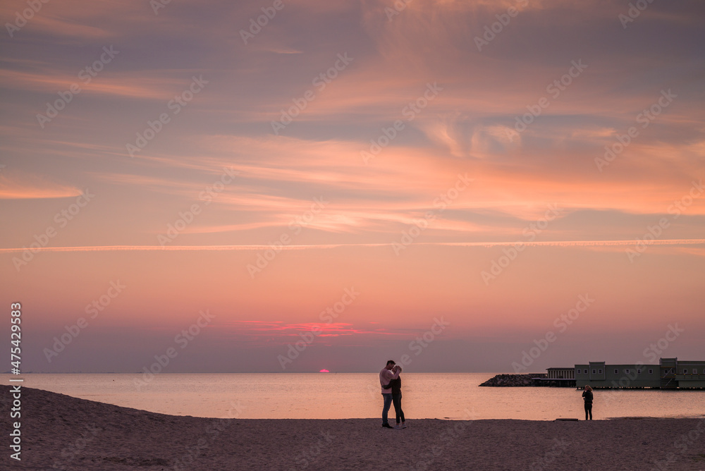 Sweden, Scania, Malmo, Riberborgs Stranden beach area, couple kissing at sunset