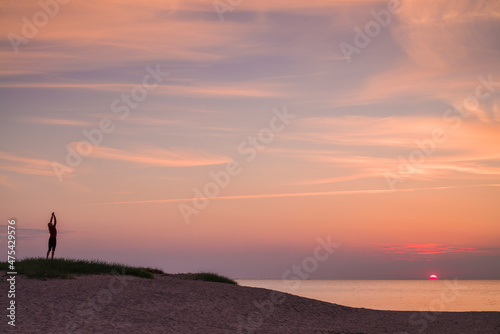 Sweden, Scania, Malmo, Riberborgs Stranden beach area, woman exercising at sunset
