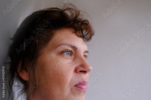 close-up part of female face of woman 40-50 years old with age wrinkles, wart over lip, concept of cosmetics, skincare, correction surgery, beauty and perfect skin, flyer for your ad antiaging