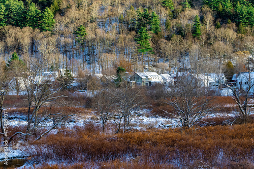 Small village town in the middle of woods and cold snow covered forest.