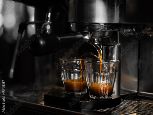 Coffee machine preparing two espressos in glasses photo