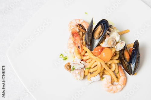 Passatelli with seafood  clams  mussels and shrimps. Typical Italian pasta most commonly cooked in broth.