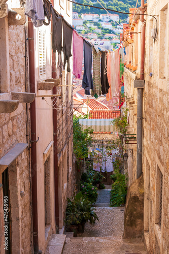 Dubrovnik, Croatia. Looking down a steep and narrow passage between buildings, with laundry strung across.