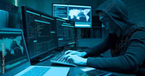 Asian male hacker use computer